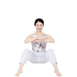 膝を開いて座り、手を組む