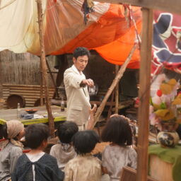 映画『宝島』より人探しをするグスク（妻夫木聡）