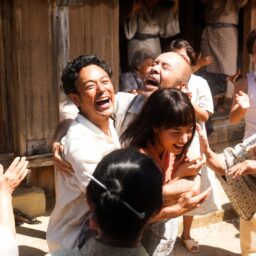 映画『宝島』より抱き合って喜ぶグスク（妻夫木聡）、ヤマコ（広瀬すず）、徳尚（塚本晋也）たち
