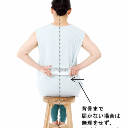 【2】肩が痛くないほうの手でペットボトルを横に引っ張り、背骨のラインに達したらその状態で10秒キープ。
