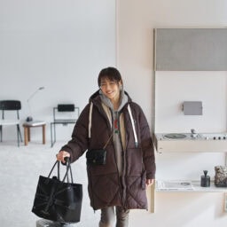 中綿コート、リバーシブルベスト／ともにオットダム、フーディ／グッチ、パンツ／カリアング、ピアス／ヴァンクリーフ＆アーペル、ポシェット／ローレン ラルフ ローレン、バッグ／A.D.M.J.、スーツケース／リモワ、ブーツ／ノーネーム（すべて私物）