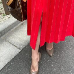「靴は、『ダイアナ』淡い色味のカーキで、いろんな服に合わせられて出番が多い靴です。秋冬にぴったりのニュアンスカラーでオレンジのセットアップとも相性良いです。スカートのスリットが、脚がきれいに見える絶妙な開きは膝の少し上と思っていて、普段は自分で縫って調整しています」