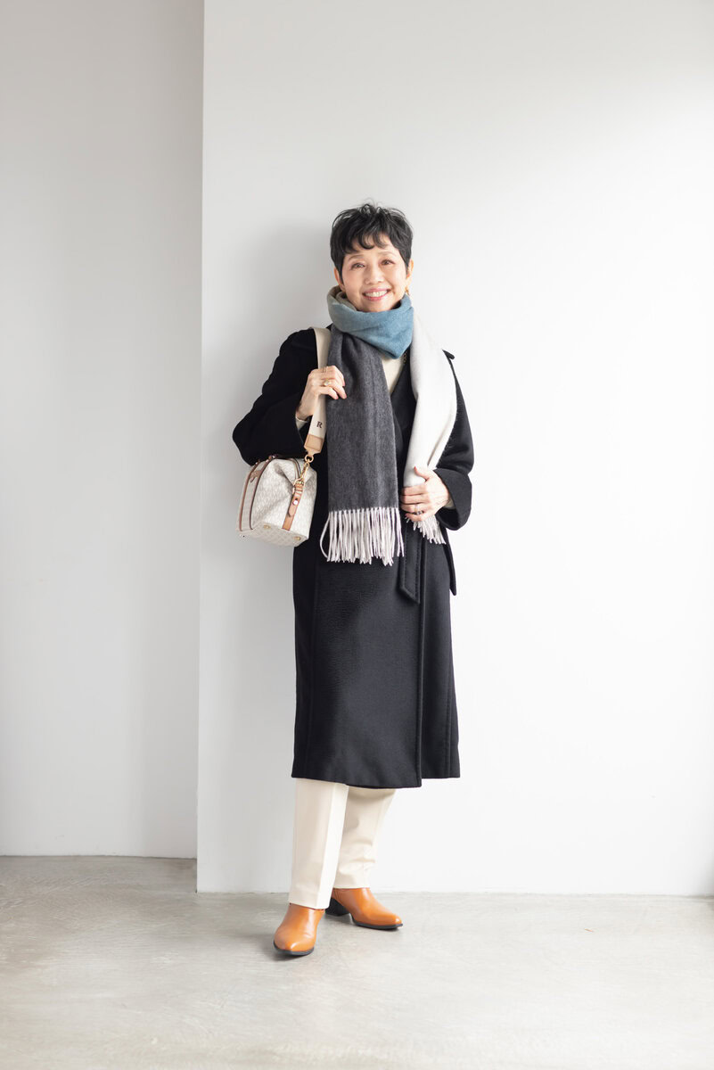 コート／マックスマーラ、タートルネックニット／ラス、パンツ／ユニクロ、ピアス／マンゴ、マフラー／田中久、ネックレス／ザラ、ベルト／ネット通販で購入、リング（左手）／宝飾店で購入、リング（右手）／アノー、バッグ／マイケル・コース、ブーツ／ジーユー（すべて私物）