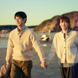 映画『人はなぜラブレターを書くのか』より手をつないで海辺を歩くナズナ（綾瀬はるか）と夫の良一（妻夫木聡）